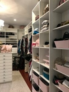 Luxury white walk-in closet with open shelving, organized hanging racks, and soft lighting for a boutique-style look