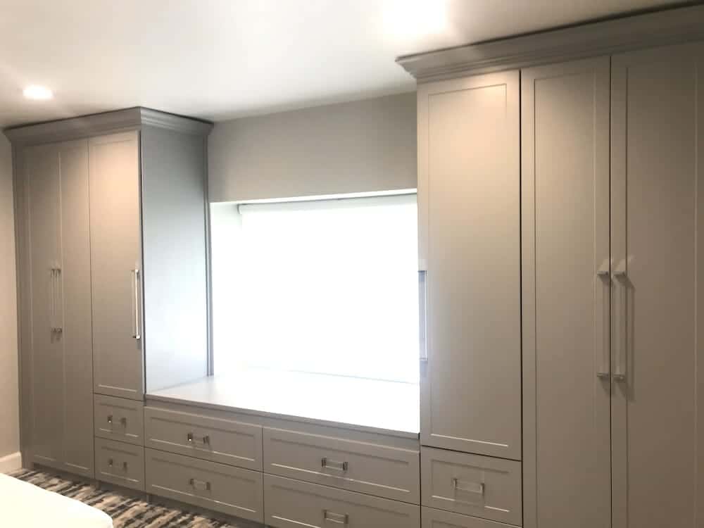 Wall-to-wall built-in wardrobe with window seat and drawers